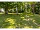 Landscaped backyard featuring mature trees that provide ample shade and enhance the property's appeal at 6164 Afton Crest, Indianapolis, IN 46220