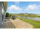 Enjoy a beautiful backyard with a pond view, patio, and landscaping, perfect for relaxation at 6315 Emerald Field Way, Indianapolis, IN 46221