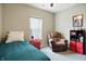 Cozy bedroom with a single bed, leather recliner, and neutral carpeting at 6315 Emerald Field Way, Indianapolis, IN 46221