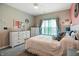 Cozy bedroom featuring a window with curtains, neutral paint, and furniture at 6315 Emerald Field Way, Indianapolis, IN 46221