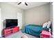 Cozy bedroom with a single bed, television, and neutral carpeting at 6315 Emerald Field Way, Indianapolis, IN 46221