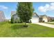 Charming single Gathering home exterior with a well maintained lawn, mature tree, and a driveway to a two-car garage at 6315 Emerald Field Way, Indianapolis, IN 46221
