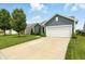 Exterior view of a single Gathering home with a two-car garage, well manicured lawn, and landscaping at 6315 Emerald Field Way, Indianapolis, IN 46221