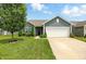 Charming single-story home featuring a well-manicured lawn, mature tree, and a two-car attached garage at 6315 Emerald Field Way, Indianapolis, IN 46221