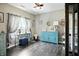 Charming living room features hardwood floors, blue cabinet and desk, and natural light from the window at 6315 Emerald Field Way, Indianapolis, IN 46221