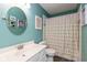 Stylish bathroom featuring a vanity, round mirror, decorative accents, and a shower with patterned curtain at 6683 Manchester Dr, Fishers, IN 46038