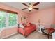 Bright bedroom with a daybed, plush pillows, a ceiling fan, and a window with outside views at 6683 Manchester Dr, Fishers, IN 46038