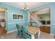 Bright dining room featuring a wooden table with seating for four and stylish chandelier lighting fixture at 6683 Manchester Dr, Fishers, IN 46038