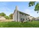 Back exterior view showcasing a well-maintained yard, patio, and siding at 6683 Manchester Dr, Fishers, IN 46038