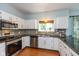 Modern kitchen with white cabinetry, stylish backsplash, stainless steel appliances, and wood-look flooring at 6683 Manchester Dr, Fishers, IN 46038