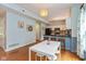 Open-concept kitchen and dining area with white cabinetry, stainless steel appliances, and stylish decor at 6683 Manchester Dr, Fishers, IN 46038