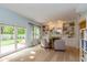 Sunlit sitting room with built-in shelving, decorative fireplace, and a sliding glass door to the backyard at 6683 Manchester Dr, Fishers, IN 46038