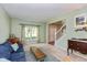 Bright living room featuring neutral carpet, large window with decorative curtains, and an open staircase at 6683 Manchester Dr, Fishers, IN 46038