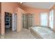 Main bathroom featuring a glass-enclosed shower, a soaking tub, and a closet at 6683 Manchester Dr, Fishers, IN 46038