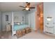 Bright main bedroom with a four-poster bed, neutral walls, and a view into the ensuite bathroom at 6683 Manchester Dr, Fishers, IN 46038