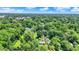 Aerial view showcasing the home and property amidst a lush landscape with mature trees at 6949 Crittenden Ave, Indianapolis, IN 46220