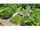 Aerial view showing the home's layout, detached garages, spacious yard, and surrounding greenery at 6949 Crittenden Ave, Indianapolis, IN 46220