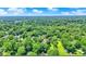 A high aerial of the property showcasing the home nestled amongst mature trees at 6949 Crittenden Ave, Indianapolis, IN 46220