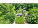 Aerial view of property showcasing generous lot, detached garages and surrounding mature trees at 6949 Crittenden Ave, Indianapolis, IN 46220