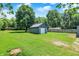 Lush backyard with green grass, detached garage and fenced perimeter at 6949 Crittenden Ave, Indianapolis, IN 46220