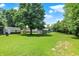 Large grassy backyard with a couple storage sheds and mature trees at 6949 Crittenden Ave, Indianapolis, IN 46220