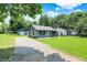 Nice home features a gravel driveway, inviting curb appeal, and detached garage at 6949 Crittenden Ave, Indianapolis, IN 46220