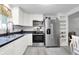 Modern kitchen with stainless appliances, white cabinets and lots of light at 6949 Crittenden Ave, Indianapolis, IN 46220