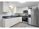 Modern kitchen featuring stainless steel appliances and white cabinetry at 6949 Crittenden Ave, Indianapolis, IN 46220