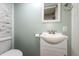 Powder room with vanity, brushed nickel faucet and marble tile accent wall at 7139 Buick Dr, Indianapolis, IN 46214