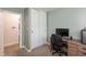 Bedroom with closet and desk area features soothing green walls and neutral carpet at 7139 Buick Dr, Indianapolis, IN 46214