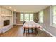 Bright dining room area with brick fireplace, hardwood floors and lots of windows at 7139 Buick Dr, Indianapolis, IN 46214