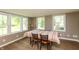 Dining area featuring wood-look floors, large windows with green outside view, and neutral walls at 7139 Buick Dr, Indianapolis, IN 46214