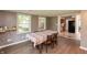 Inviting dining area with hardwood floors, views to the backyard, and adjacent to the kitchen at 7139 Buick Dr, Indianapolis, IN 46214