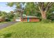 Quaint brick house featuring a manicured lawn and large tree providing ample shade at 7139 Buick Dr, Indianapolis, IN 46214
