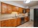 Traditional kitchen with wood cabinetry, tile backsplash, and stainless steel appliances at 7139 Buick Dr, Indianapolis, IN 46214