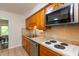 Bright kitchen with stainless steel microwave, wood cabinets, and white countertops at 7139 Buick Dr, Indianapolis, IN 46214