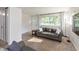 Bright living room features neutral carpet, large window with curtains, and comfortable couches at 7139 Buick Dr, Indianapolis, IN 46214