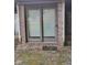 Brick back patio features sliding glass doors and a small welcome mat at 721 Maplewood Ave, Anderson, IN 46012