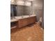 Bathroom featuring a dual sink vanity with light wood finish, parquet floors and a toilet at 721 Maplewood Ave, Anderson, IN 46012