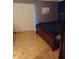 Cozy bedroom with parquet floors, a painting, and a window with light-filtering blinds at 721 Maplewood Ave, Anderson, IN 46012