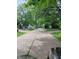 Long driveway leading to a home surrounded by mature trees and green lawns at 721 Maplewood Ave, Anderson, IN 46012