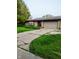 Brick single-story house with an attached two-car garage and a concrete driveway at 721 Maplewood Ave, Anderson, IN 46012