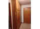 A hallway featuring built-in wooden storage cabinets offering ample storage space and classic charm at 721 Maplewood Ave, Anderson, IN 46012
