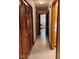 Hallway with wood cabinets and closet and view to the door, offering a glimpse of the home's layout at 721 Maplewood Ave, Anderson, IN 46012