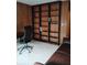 Home office with a custom wooden bookshelf and a comfortable chair, perfect for working from home at 721 Maplewood Ave, Anderson, IN 46012