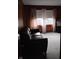 The living room has carpet, wood paneling, and a window with floral curtains at 721 Maplewood Ave, Anderson, IN 46012