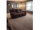 Cozy living room with a plush brown sofa and a view into another room at 721 Maplewood Ave, Anderson, IN 46012
