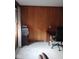Home office featuring wood paneling, large windows, desk, and a printer at 721 Maplewood Ave, Anderson, IN 46012
