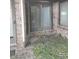Enclosed patio space with brick surround and glass sliding doors to the interior of the house at 721 Maplewood Ave, Anderson, IN 46012