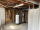 Unfinished basement area featuring exposed ceiling with updated water heater and modern Bryant furnace at 737 Howard St, Shelbyville, IN 46176